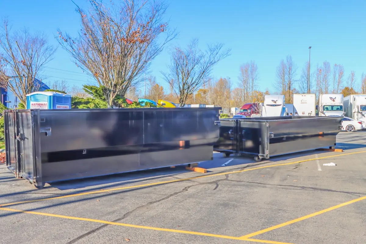 Professional dumpster rental service with roll-off container on residential driveway in Key West